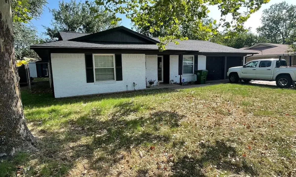Professional roofing crew working on a residential roof in Branson